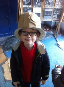 Child wearing a cardboard hat