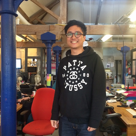 A photograph of Eric standing in the Delib office