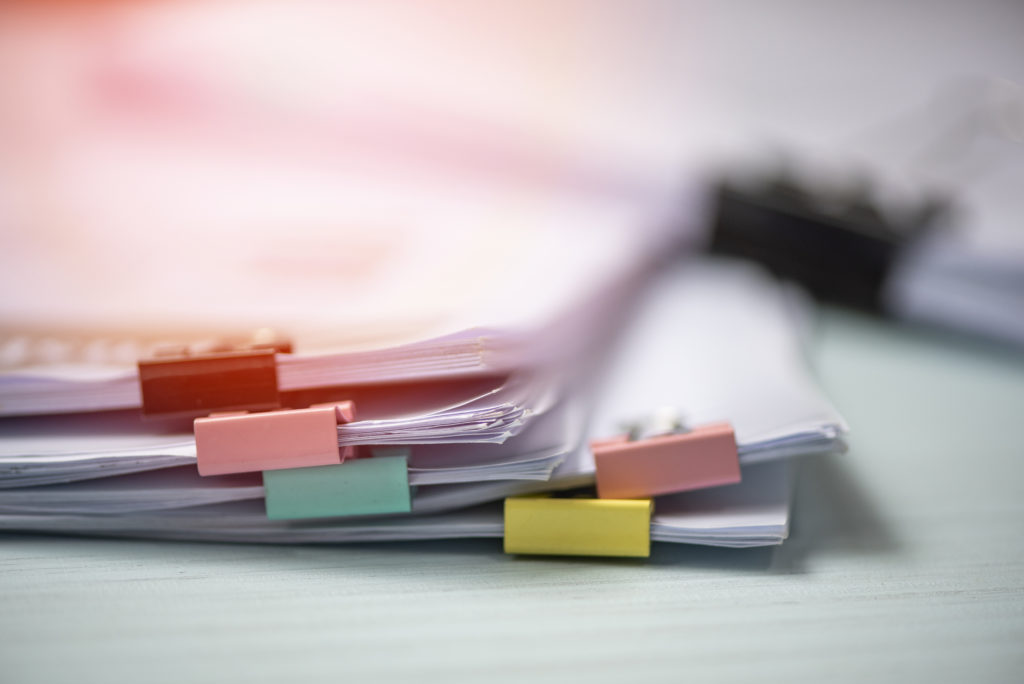 Pile of documents organised with colourful clips